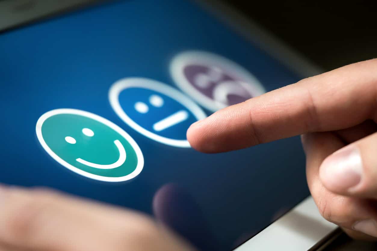 close up of finger leaving a positive review on tablet