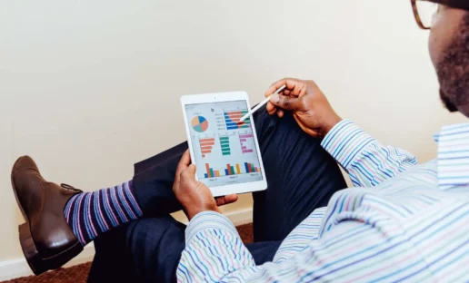 man holding an ipad showing an Interaction Metrics customer feedback dashboard
