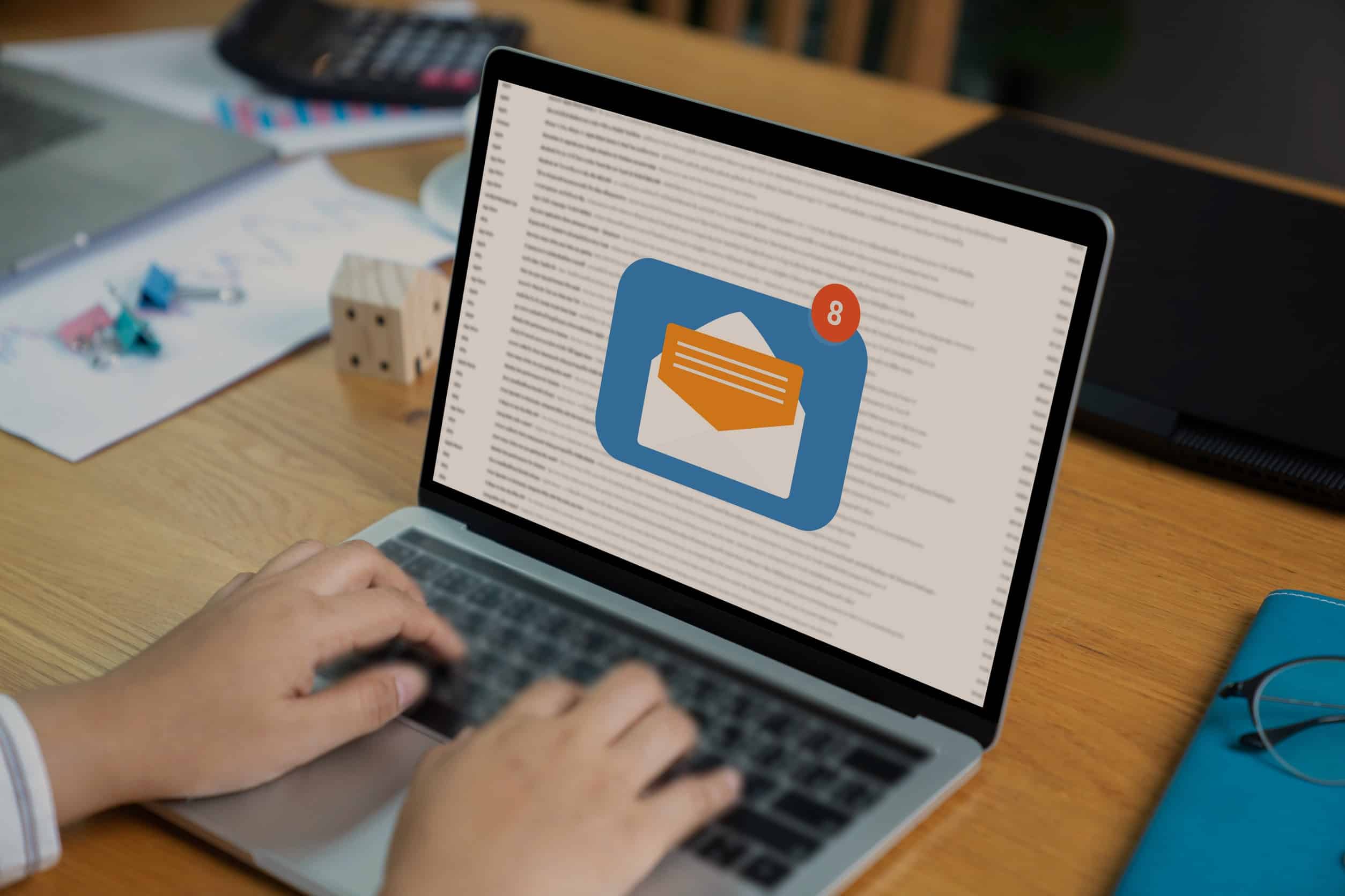 person receiving an email on a laptop from interaction metrics about how to improve survey results